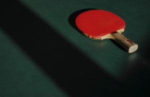 Empty ping pong table with racket.